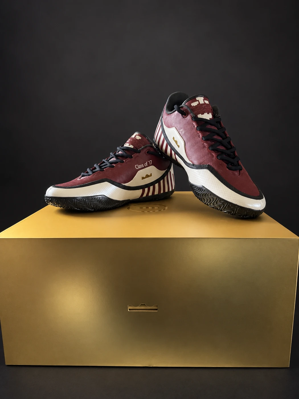 Completed burgundy and cream Indiana-inspired custom sneakers displayed together on a gold shoe box