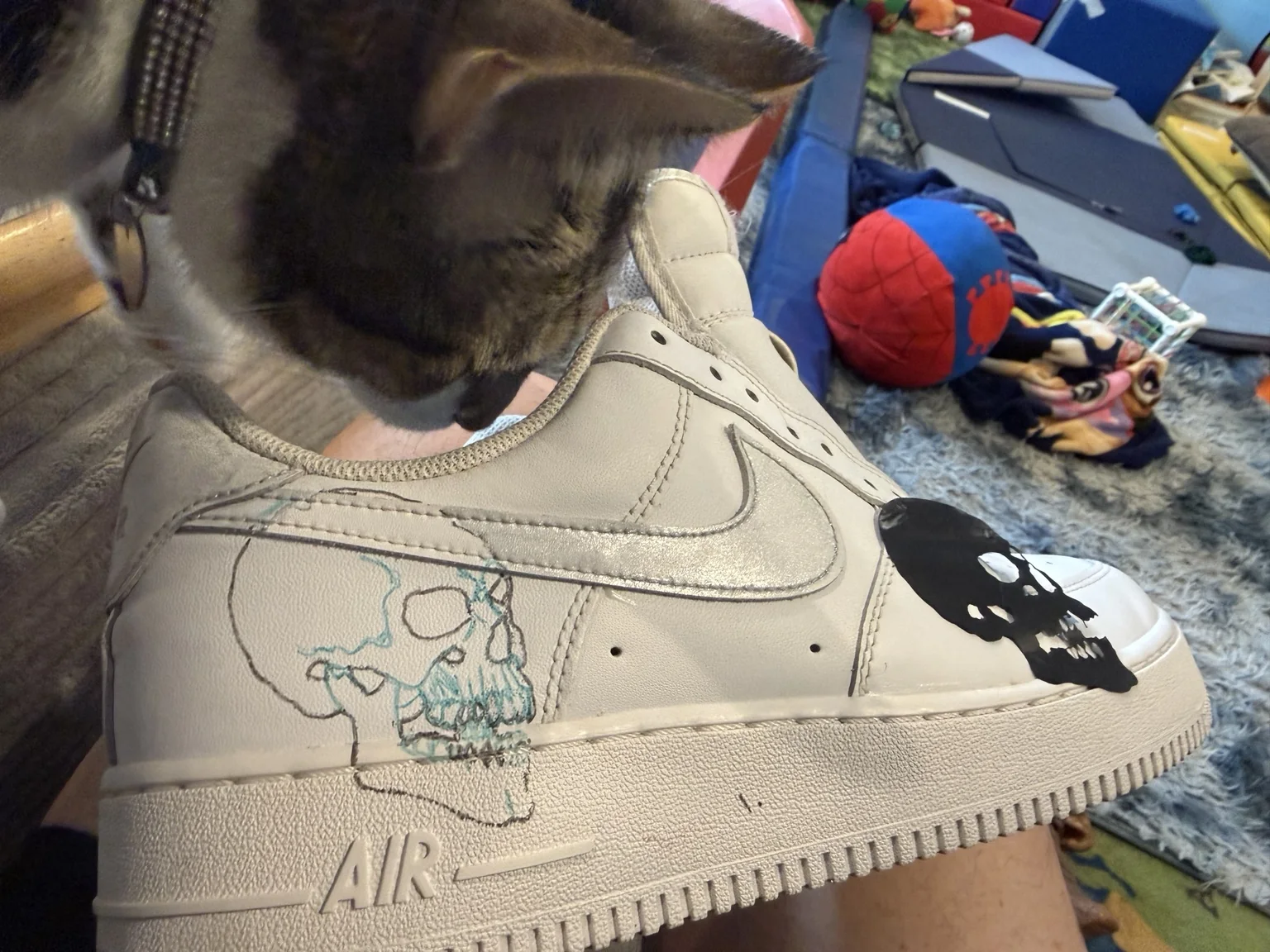 Custom skull artwork being sketched on a sneaker