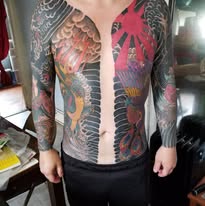 Large-scale back tattoo and sleeves by the local artist